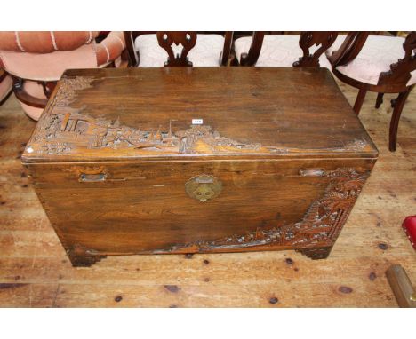 Oriental carved camphorwood trunk, 59.5cm by 105cm by 51cm.