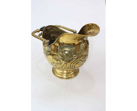 Late Victorian embossed brass coal helmet with ebony handles.