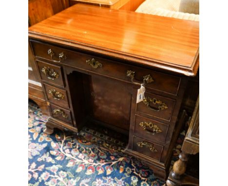 A George III and later mahogany kneehole desk, fitted seven drawers and recessed cupboard on ogee bracket feet, width 81cm, d