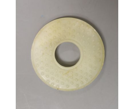 A Chinese pale celadon jade bi disc, 6cm diameter