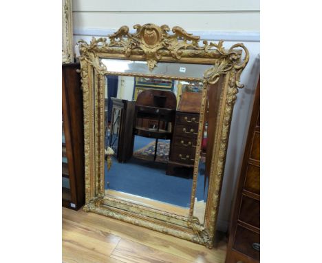A large 19th century French gilt and gesso frame, bevel edged mirror with cushion margin, plated and C scroll, width 108cm, h