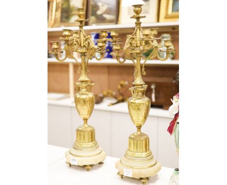 A pair of Louis XVI style four branch, five light gilt brass candelabra, with vase shaped stem, on shaped alabaster plinths76