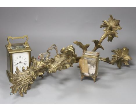 A brass carriage timepiece, a brass casket containing silver watch and a brass rococo-style twin-sconce wall light