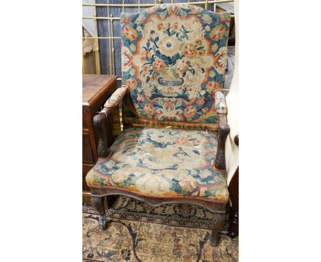 An 18th century French carved walnut elbow chair with tapestry upholstery, width 60cm, depth 58cm, height 104cm