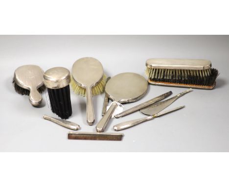 A 1940's silver mounted hand mirror and a group of other silver or sterling mounted brushes etc.