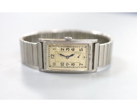 A gentleman's 1930's? stainless steel Omega manual wind rectangular dial wrist watch, on associated flexible bracelet, case d