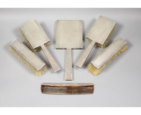 A George VI engine turned silver mounted Art Deco five piece mirror and brush set, S.J. Rose &amp; Son, London, 1947 and an a
