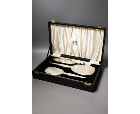 A modern cased engine turned silver three piece brush set.