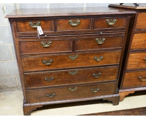A George III oak chest,fitted five short drawers and three long drawers with brass swan-neck handles, on square bracket feet,