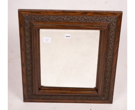 An early 20th century carved oak rectangular wall mirror, width 57cm, height 64cm