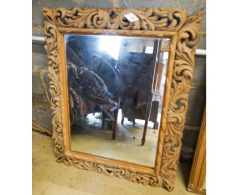 A carved oak framed rectangular wall mirror, width 65cm, height 82cm