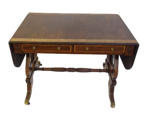 A Regency mahogany, coromandel and burr satinwood sofa table the rectangular top with rounded twin flaps above two drawers an