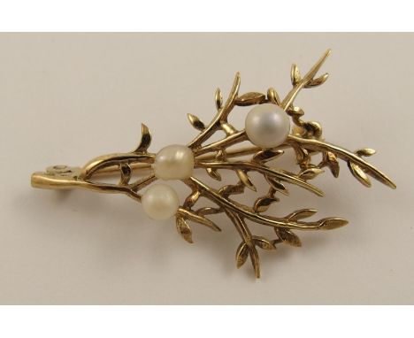 A 9ct Scottish pearl set brooch the golden leafy branch is set with three natural Scottish river pearls, and was retailed by 