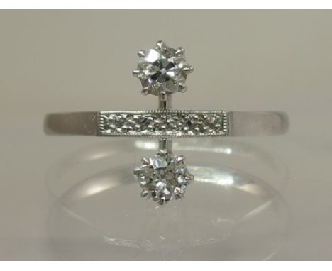 An 18ct white gold and platinum twin stone diamond ring the combined approx diamond weight is 0.30cts in unusual Art Deco set