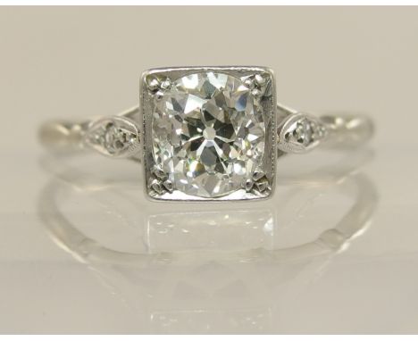 An Art Deco solitaire old cut diamond ring of approx 0.85cts, in an 18ct white gold and platinum mount, with diamond set shou