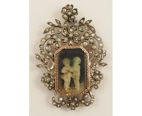 A Victorian mourning pendant in a split pearl yellow and white metal floral mount, with a central panel painted in monochrome