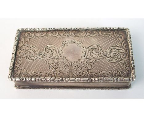 A silver snuff box by Gervase Wheeler, Birmingham 1884, of rectangular shape, the hinged cover with gadrooned edge, foliate e