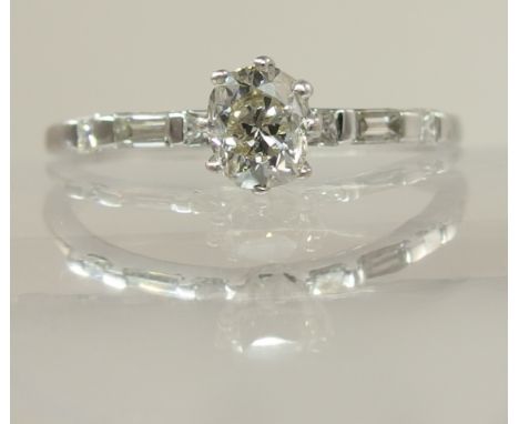 An old cut diamond ring the oval old cut diamond of approx 0.50cts has been re set into a modern ring with further baguettes 