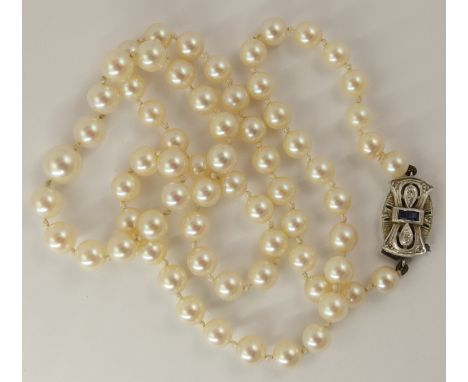 A gently taped string of pearls with a 9ct Art Deco sapphire and diamond clasp, largest pearl approx 9mm, smallest 6.1mm, len