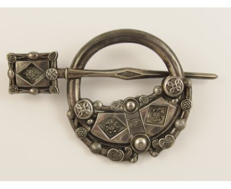 An Irish silver plaid brooch of traditional Celtic design of bosses and knotwork, and the reverse with zoomorphic forms, stam