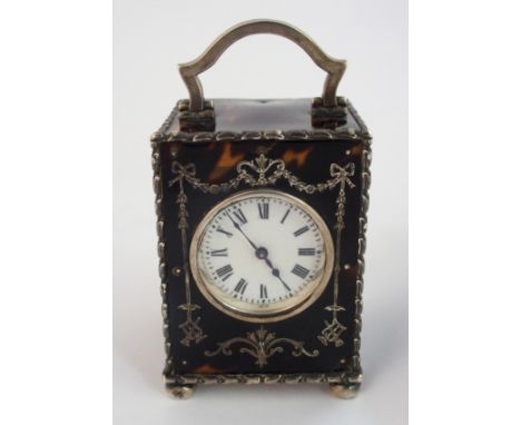 A lady's table carriage clock in silver and tortoiseshell by William Comyns & Sons, London 1908, of rectangular form with Fre