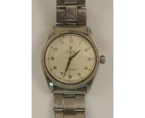 A Vintage stainless steel Rolex Oyster Perpetual with a cream dial Arabic silver coloured numerals, a gold coloured sweeping 