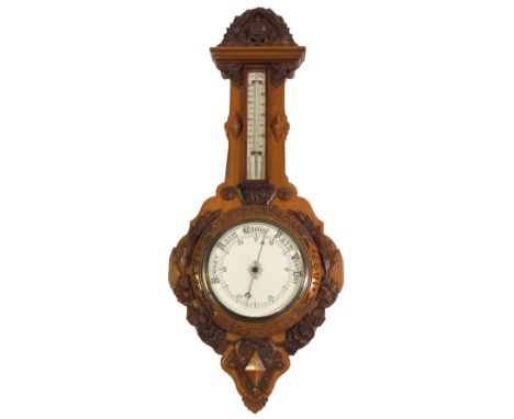 A Victorian walnut Diamond Jubilee commemorative barometer and thermometer carved with a crown enclosed by a carved laurel wr