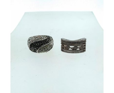 Ring 1: domed shape with light blue and clear cubic zirconia stones. Ring 2: thick band with small cubic zirconia stones, Bot