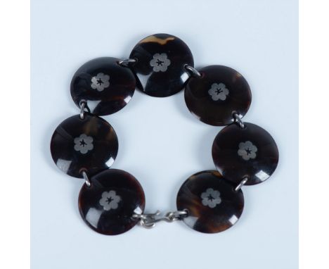 Unique domed circular tortoise links with sterling silver floral inlay. Hook and loop closure. A truly lovely bracelet. 7.75"
