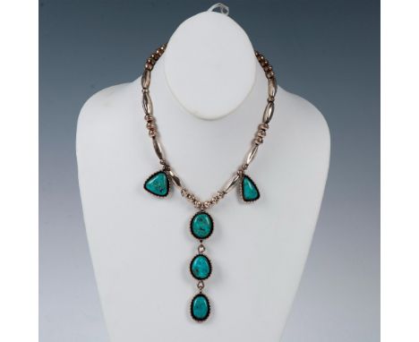 A handmade Southwest Native American piece. Navajo style necklace with sterling silver beads and five turquoise stones housed