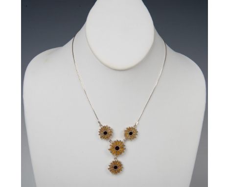 This fun flower necklace is charming. On a delicate sterling silver chain are three connected flowers with one more dangling 