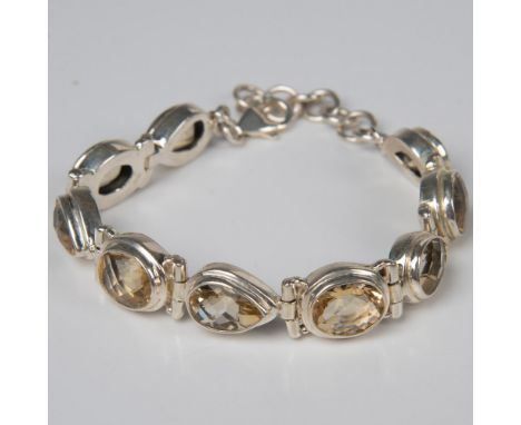 Glistening pear and oval shaped faceted citrine stones form this lovely bracelet. The stones are set in sterling silver with 