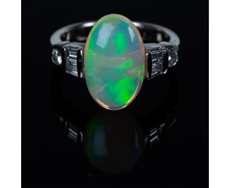 Beautiful ring with 4 baguette-cut and 2 round brilliant-cut diamonds. It has a large center opal stone that weighs 3.86cts. 