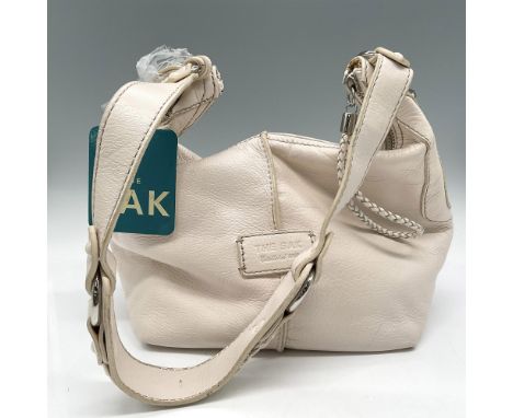 Top stitch on genuine leather with braided leather accents on pull and base of purse. Silver toned hardware. Minor stain on b