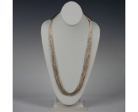 Many strands of silver round and tube beads with cone tips marked Sterling and a hook clasp. 72g. Dimensions: 29.5"LCondition
