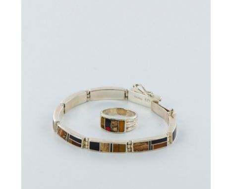 Stylish hinged bracelet with inlay stones of browns, golds and tans. Bracelet has a rectangular box clasp with a security cli