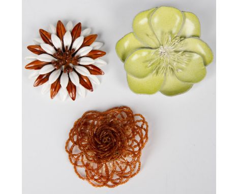 Three lovely blooming flower brooches. One is a pastel green leather with a fluffy filament center. The back has a pin and a 