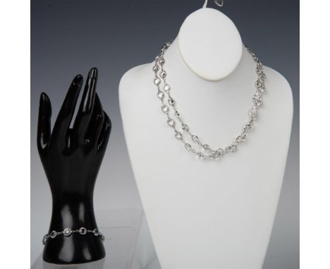 Elegant and timeless. Vibrant clear crystal bezel necklace and bracelet in silver tone setting. The necklace has the swan hal