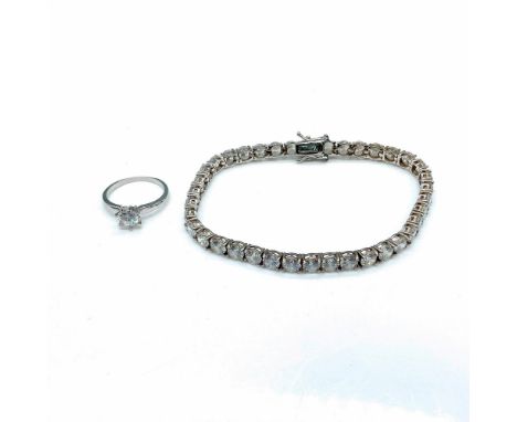 The bracelet is set with clear stones and measures 8.5"L and marked 925 for sterling silver.Â&nbsp;The silver tone ring is se