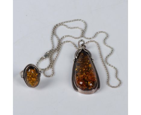 Beautiful necklace and ring made from amber and sterling silver. All pieces are stamped 925. The pendant measures 2.75"L x 1"