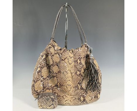 Extra large satchel holds it all. The top edge is gathered around the thick woven leather handles. Long zip pockets on both e