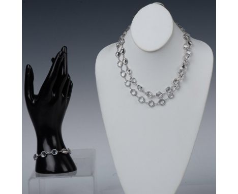 Elegant and timeless. Vibrant clear crystal bezel necklace and bracelet in silver tone setting. The necklace has the swan hal