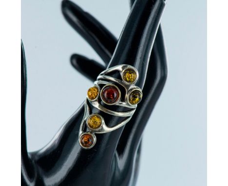 Lovely freeform sterling silver design with scattered multi color cabochon amber stones. This ring hugs the finger beautifull