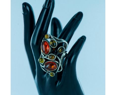 Stunning freeform sterling silver with multi color and size cabochon stones. Size 7.5. Design: 2"L x 1.25"W. Issued: 20th cen