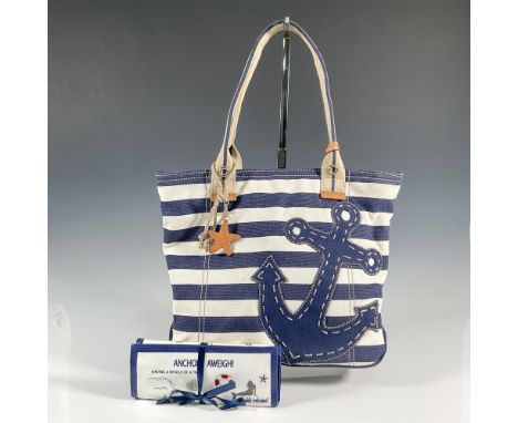 Navy and off white striped canvas handbag with interior pockets, zippered closure, leather straps and accents; 15"L x 3"W x 1