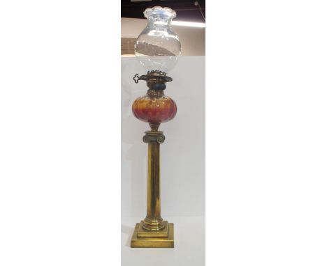 A Victorian brass column oil lamp with glass font and shade, 82cm high Condition Report:Available upon request