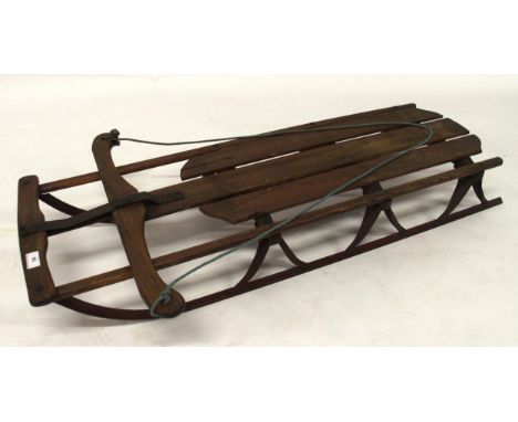 A 20th century beech and iron child's sled, 115cm long x 58cm wide x 19cm high Condition Report:Available upon request