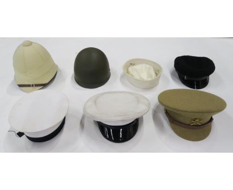 An assortment of mainly reproduction military and other headgear, to include a pith helmet, Machine Gun Corps officer's cap, 