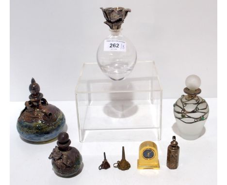 A silver mounted scent bottle, another smaller, other scent bottles, funnels and a Jeanier miniature quartz clock with opal c