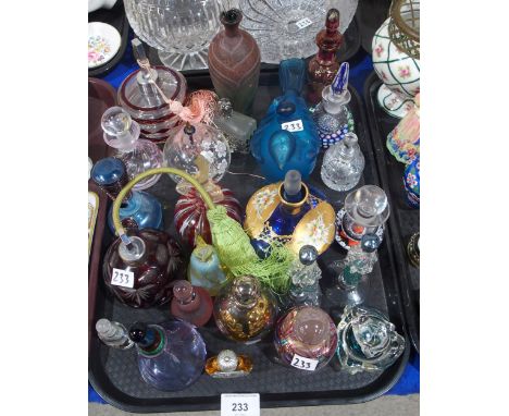 A collection of scent bottles including Caithness and Perthshire millefiori examples, Stuart Akroyd, and others and a pair of